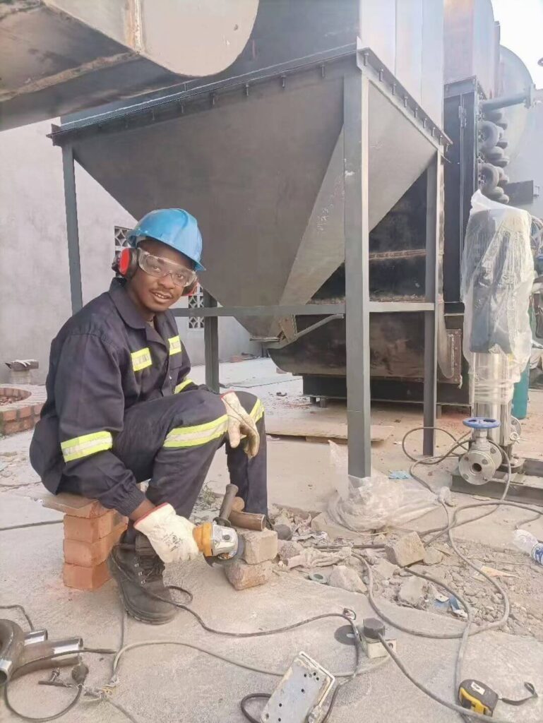 Taiguo engineers performing precision welding on an industrial biomass boiler steam header